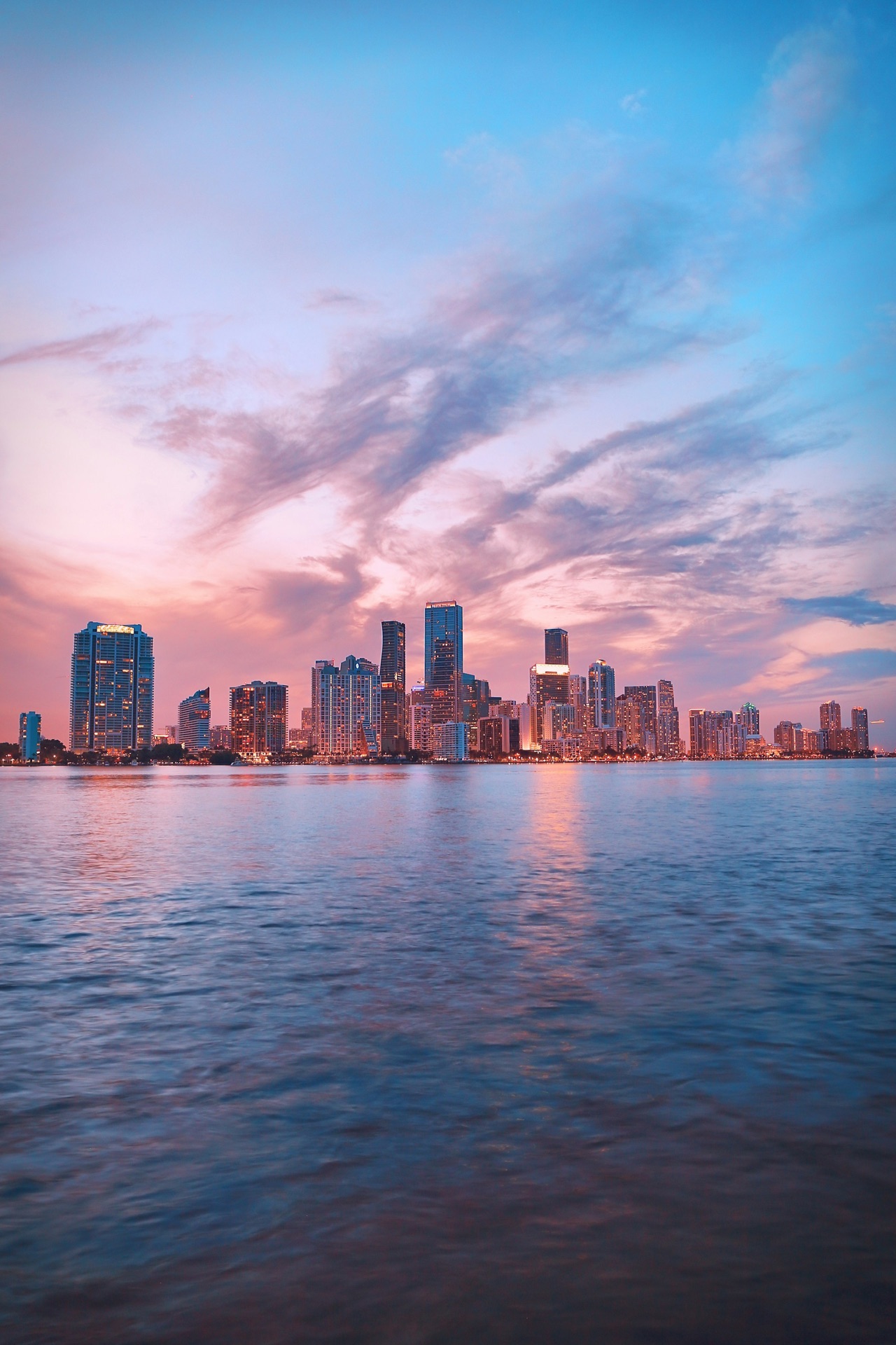 Miami skyline reflected across Biscayne Bay at dusk